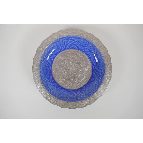 128 - A Chinese blue glazed porcelain dish with a lobed rim and silvered details, decorated with lotus flo... 