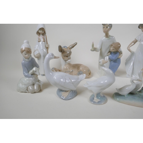 139 - A collection of fourteen Lladro and Nao figurines and animals, largest 22cm high