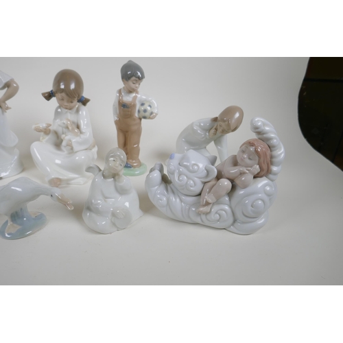 139 - A collection of fourteen Lladro and Nao figurines and animals, largest 22cm high