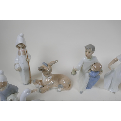 139 - A collection of fourteen Lladro and Nao figurines and animals, largest 22cm high