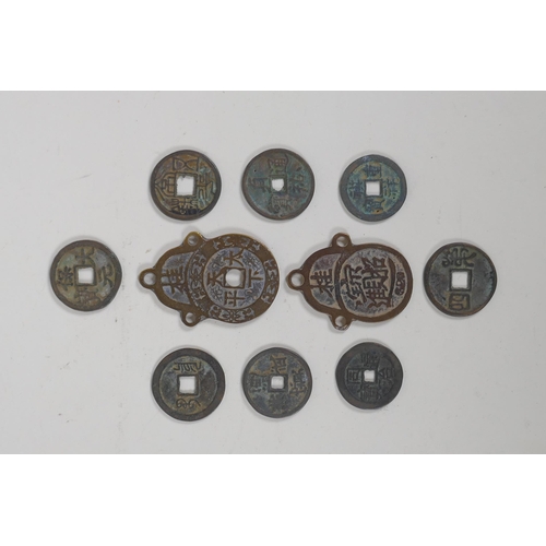 152 - Eight Chinese facsimile (replica) bronze coins, and a pair of Chinese bronze medallions, 4 x 6cm