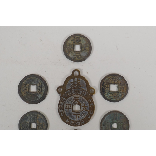 152 - Eight Chinese facsimile (replica) bronze coins, and a pair of Chinese bronze medallions, 4 x 6cm