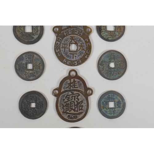 152 - Eight Chinese facsimile (replica) bronze coins, and a pair of Chinese bronze medallions, 4 x 6cm