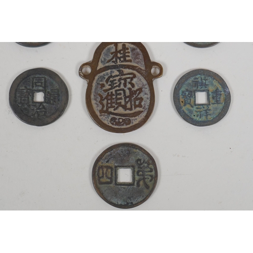 152 - Eight Chinese facsimile (replica) bronze coins, and a pair of Chinese bronze medallions, 4 x 6cm