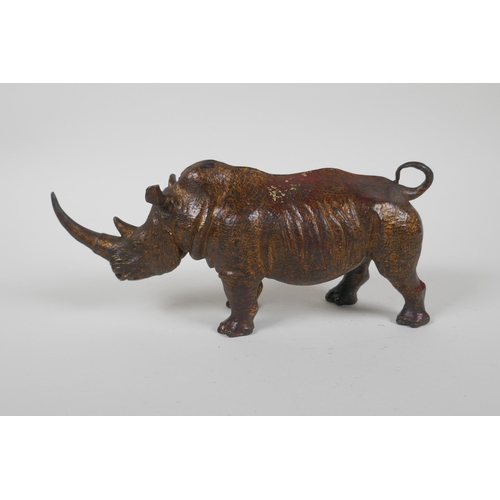 153 - A gilt bronzed metal rhinoceros, filled, 25cm long