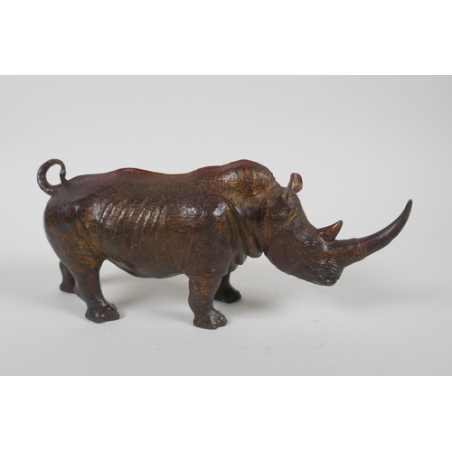 153 - A gilt bronzed metal rhinoceros, filled, 25cm long