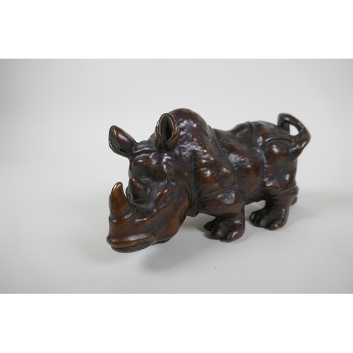 162 - A bronzed metal rhinoceros, filled, 19cm long