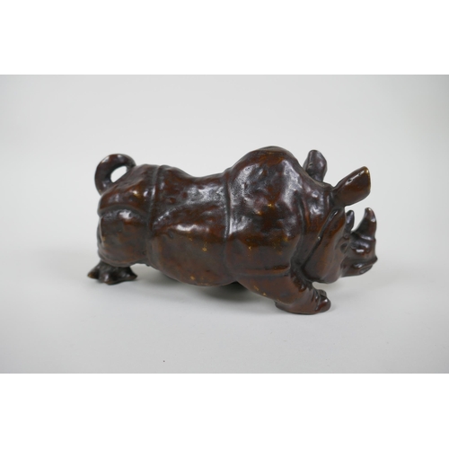 162 - A bronzed metal rhinoceros, filled, 19cm long