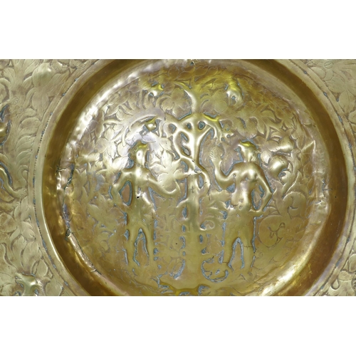 170 - A Nuremburg brass alms dish, the central field with a depiction of Adam and Eve with the Tree of Kno... 