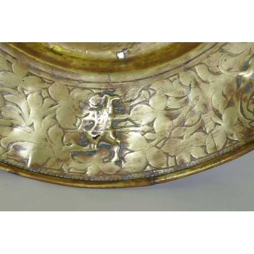 170 - A Nuremburg brass alms dish, the central field with a depiction of Adam and Eve with the Tree of Kno... 