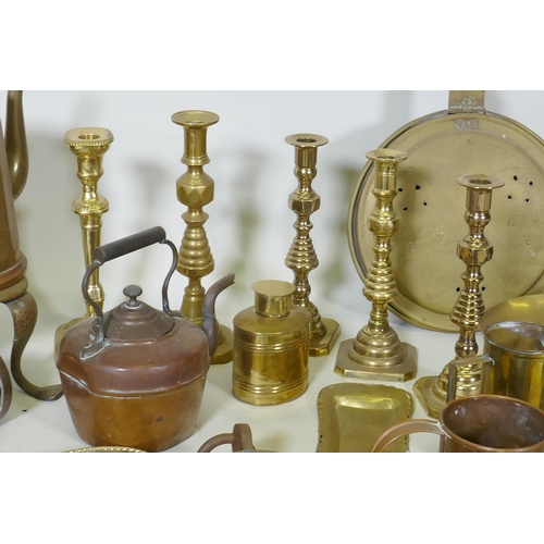 178 - A quantity of copper and brass, footman skillets, candlesticks, bed warmers, set of postage scales w... 