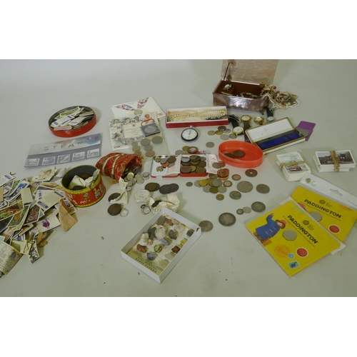 192 - A quantity of UK and world coins, costume jewellery, stamps, cigarette cards, watches, Omega stop wa... 