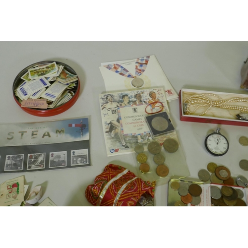 192 - A quantity of UK and world coins, costume jewellery, stamps, cigarette cards, watches, Omega stop wa... 