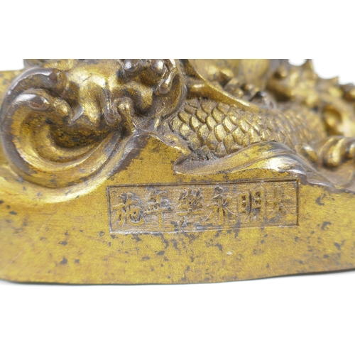 201 - A Sino Tibetan gilt bronzed metal Buddha seated on a cobra throne, impressed Yongle 6 character mark... 