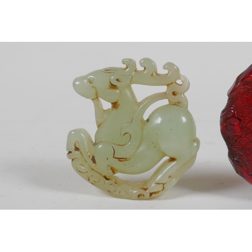 208 - A Chinese carved hardstone roundel in the form of a deer, and a faux amber snuff bottle, 7cm high