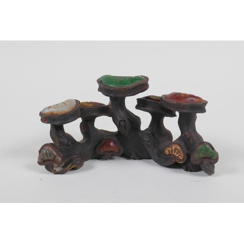 211 - A Chinese cast iron brush rest in the form of Ruyi, set with assorted colored hardstones, 13cm long