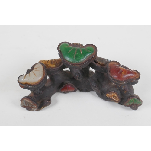 211 - A Chinese cast iron brush rest in the form of Ruyi, set with assorted colored hardstones, 13cm long