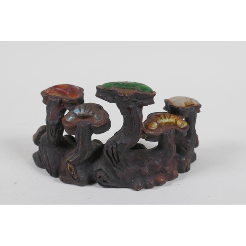 211 - A Chinese cast iron brush rest in the form of Ruyi, set with assorted colored hardstones, 13cm long