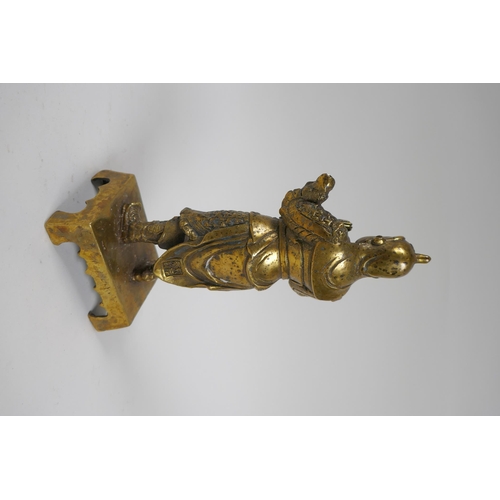 217 - A Chinese gilt bronze figure of an immortal in armour, 4 character mark verso, 23cm high