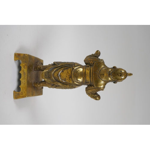 217 - A Chinese gilt bronze figure of an immortal in armour, 4 character mark verso, 23cm high