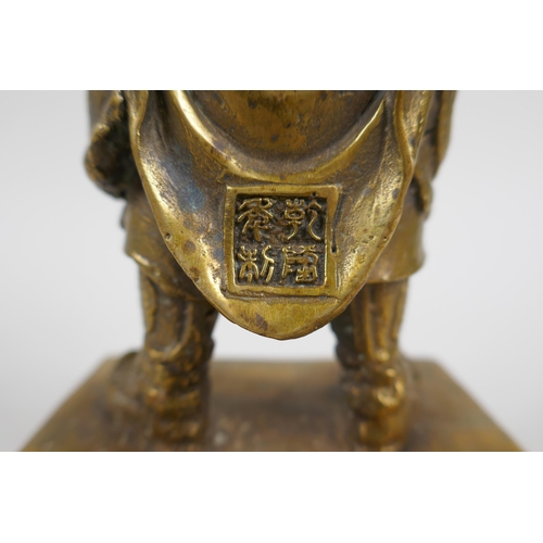 217 - A Chinese gilt bronze figure of an immortal in armour, 4 character mark verso, 23cm high