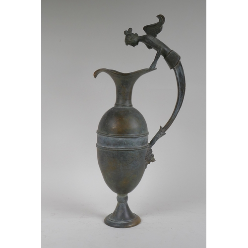 219 - A Greco-Roman style bronze urn, the handle decorated with the bust of a siren, 48cm high