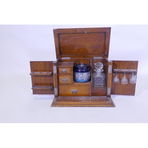 223 - A Victorian golden oak smoker's companion, with two doors opening to reveal a fitted interior with s... 