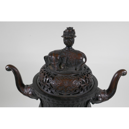 243 - A Chinese bronzed metal two handled censer and pierced cover, raised on elephant head tripod support... 