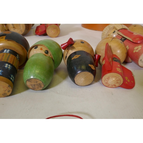 250 - Seventeen vintage Japanese Kokeshi painted wood dolls, some signed, largest 25cm high