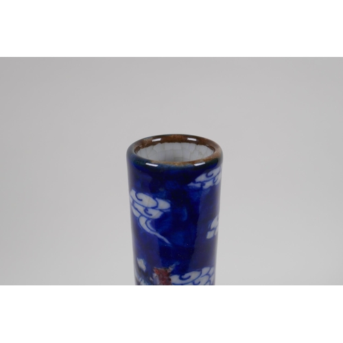 251 - A Chinese crackleware bottle vase with blue, white and red decoration of a dragon and phoenix in fli... 