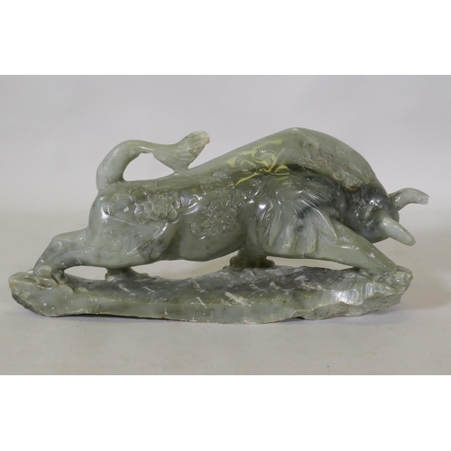 255 - A Chinese carved soapstone figure of a bull, 58 x 28cm