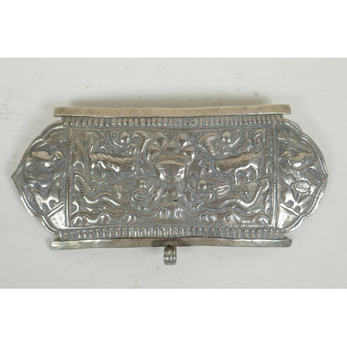 284 - A Chinese repousse white metal belt buckle decorated with mythical creatures and a goblet, 21 x 10cm