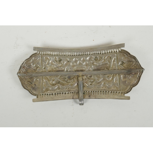 284 - A Chinese repousse white metal belt buckle decorated with mythical creatures and a goblet, 21 x 10cm