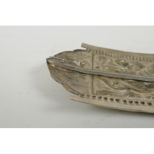 284 - A Chinese repousse white metal belt buckle decorated with mythical creatures and a goblet, 21 x 10cm