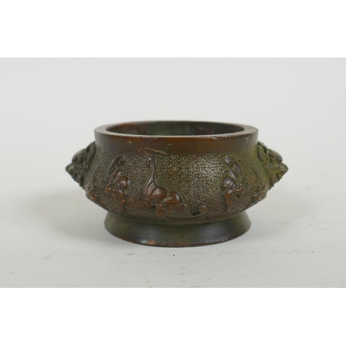 287 - A Chinese bronze censer with two lion mask handles and raised bat decoration, Qianlong 4 character m... 