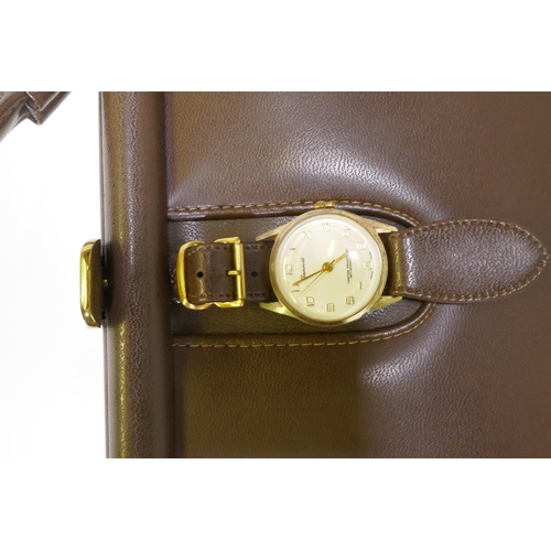 288 - A vintage leather handbag with Genovit watch clasp and brass mounts, 27 x 20cm