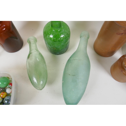 309 - A quantity of vintage glass bottles, stone ware pots and marbles, largest 23cm