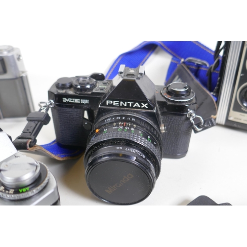 315 - A quantity of vintage cameras and equipment, including a Canon Coronet 28, a Canon AV 1, a Pentax ME... 