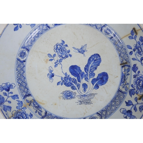 338 - A C19th Delft tin glazed charger decorated with flowers and butterflies, AF, historic repair, 31cm d... 