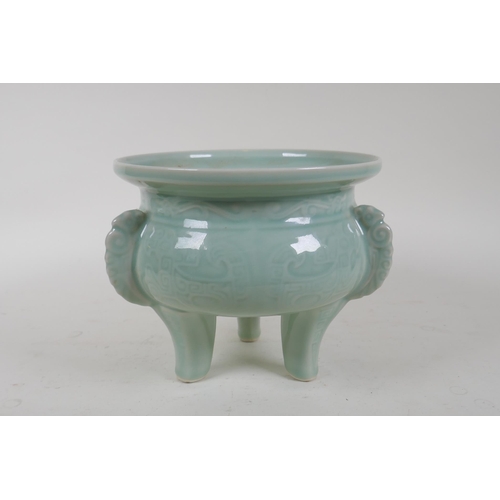 340 - An oriental celadon glazed porcelain censer with tripod supports and archaic underglaze decoration, ... 