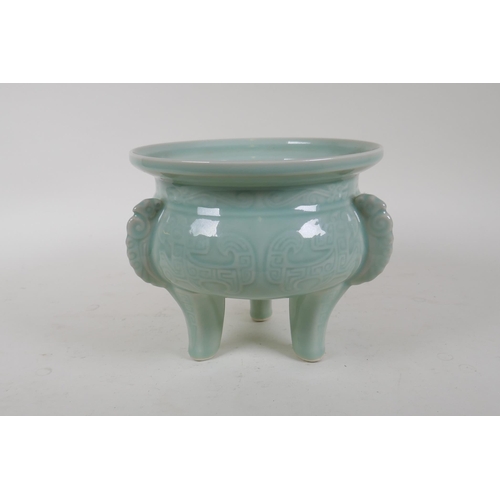 340 - An oriental celadon glazed porcelain censer with tripod supports and archaic underglaze decoration, ... 