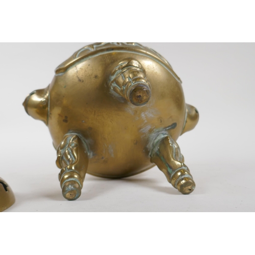 342 - A Chinese bronze censer and cover on tripod supports, with twin mask handles, kylin knop and decorat... 