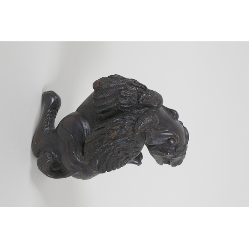 40 - A Chinese bronze figure of a winged mythical beast, 10cm high