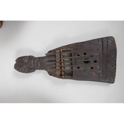 46 - An African antique carved hardwood Kalimba in the form of a figure, together with a carved root wood... 