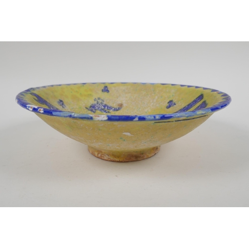 50 - An antique Islamic pottery bowl decorated with birds and script, chips to glaze, 24cm diameter