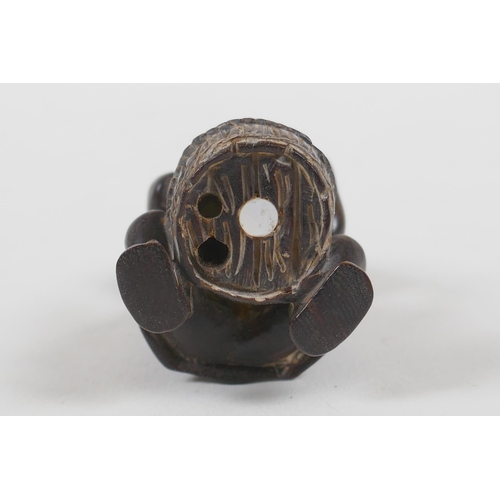 57 - A Japanese carved wood netsuke in the form of a man making mochi, 5cm high