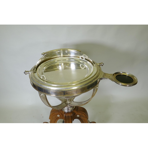 611 - A silver plated revolving meat carving trolley with roll top cover raised on a wood base with castor... 