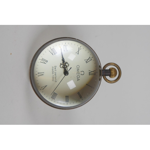 612 - A brass bound glass ball desk clock, 6cm diameter