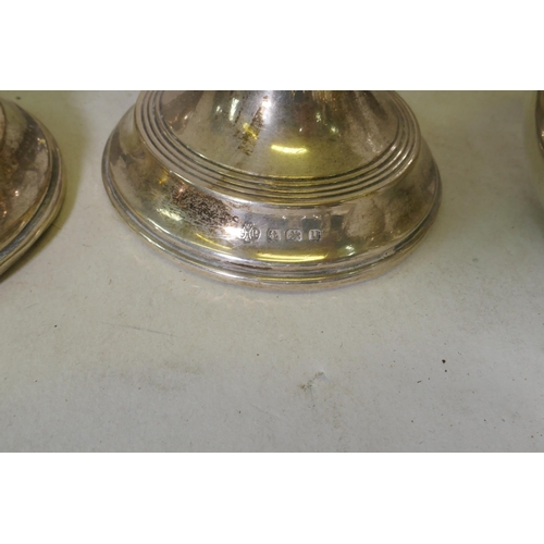 634 - A pair of hallmarked silver candlesticks, Elkington silver plated cocktail shaker, four piece tea se... 