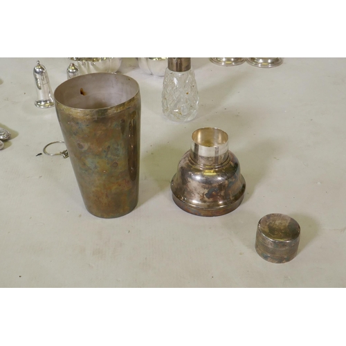 634 - A pair of hallmarked silver candlesticks, Elkington silver plated cocktail shaker, four piece tea se... 